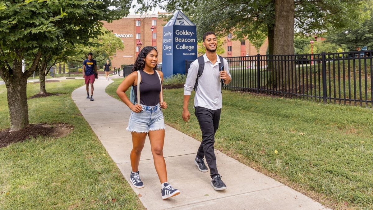 two students walking on goldy beacom college campus